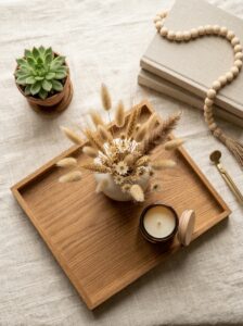 Elegant home decor flat lay with ceramic vase dried flowers and cozy accessories